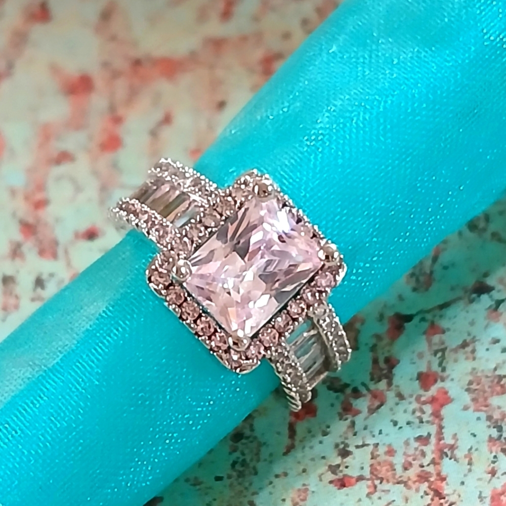 Silver and White Ring with Princess-Cut Stone and Intricate Detailing